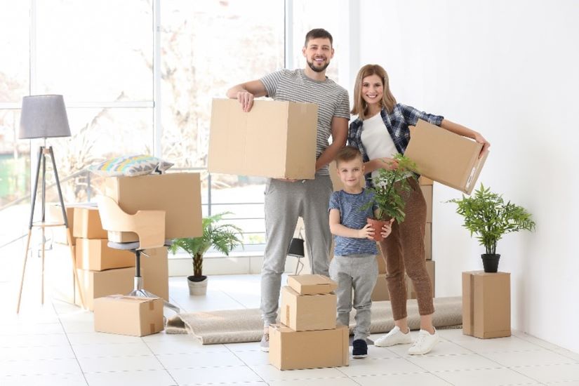 young family moving house packing boxes